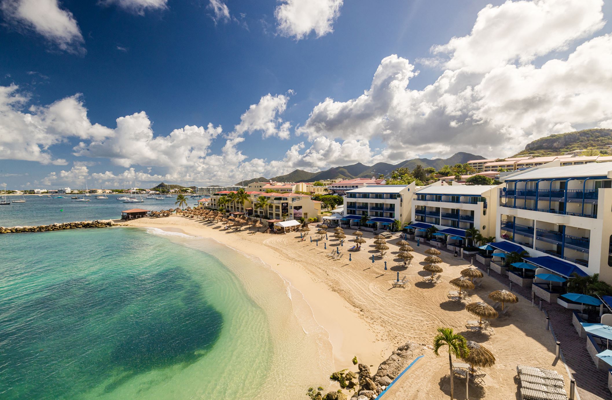 An aerial photo of the exterior of Hilton Vacation Club Flamingo Beach with the copy 'St. Maarten. Flamingo Beach. Pool & Hot Tub'.