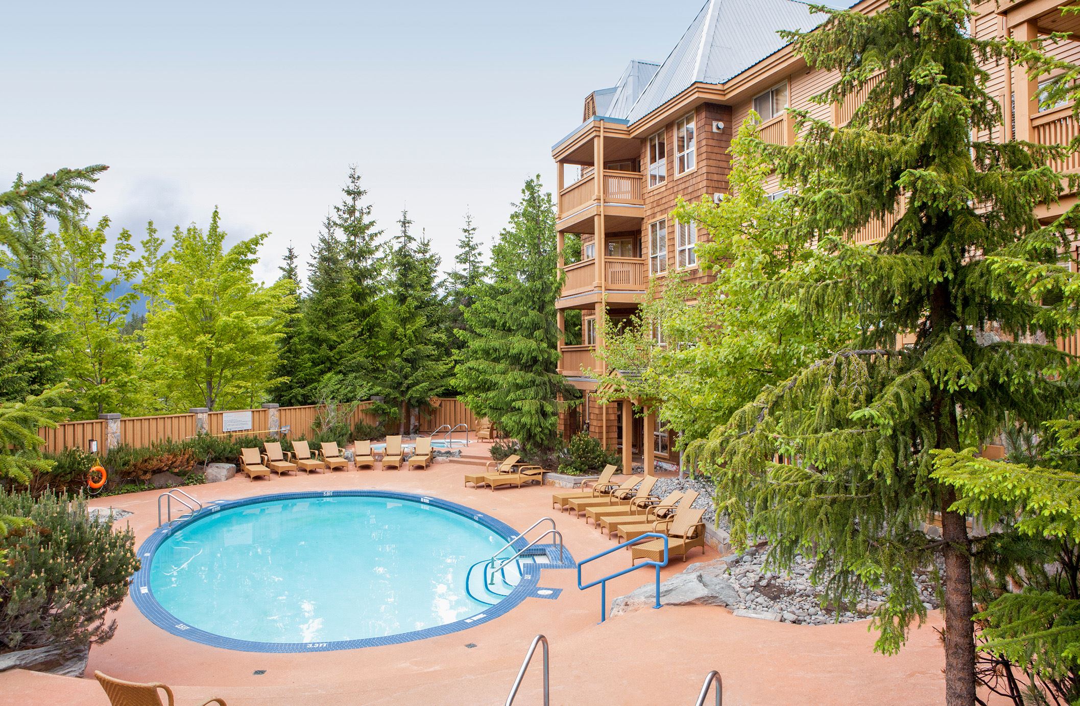 An exterior photo of Hilton Grand Vacations Club Whistler with the copy 'British Colombia. Canada. Hilton Grand Vacations Club Whistler. Pool & Hot Tub'.