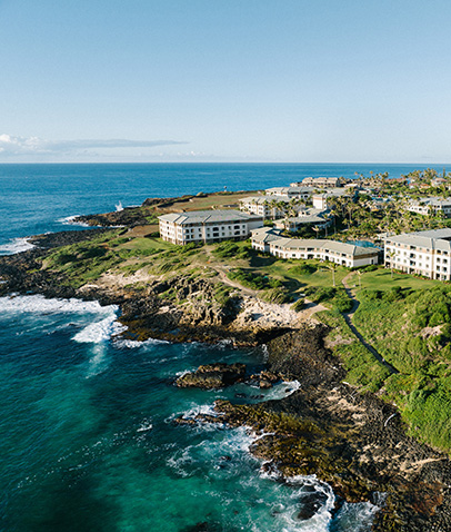 An aerial photo of The Point at Poipu HGV Resort with the copy 'Koloa Hawaii, The Point at Poipu - Pool & Hot Tub'.