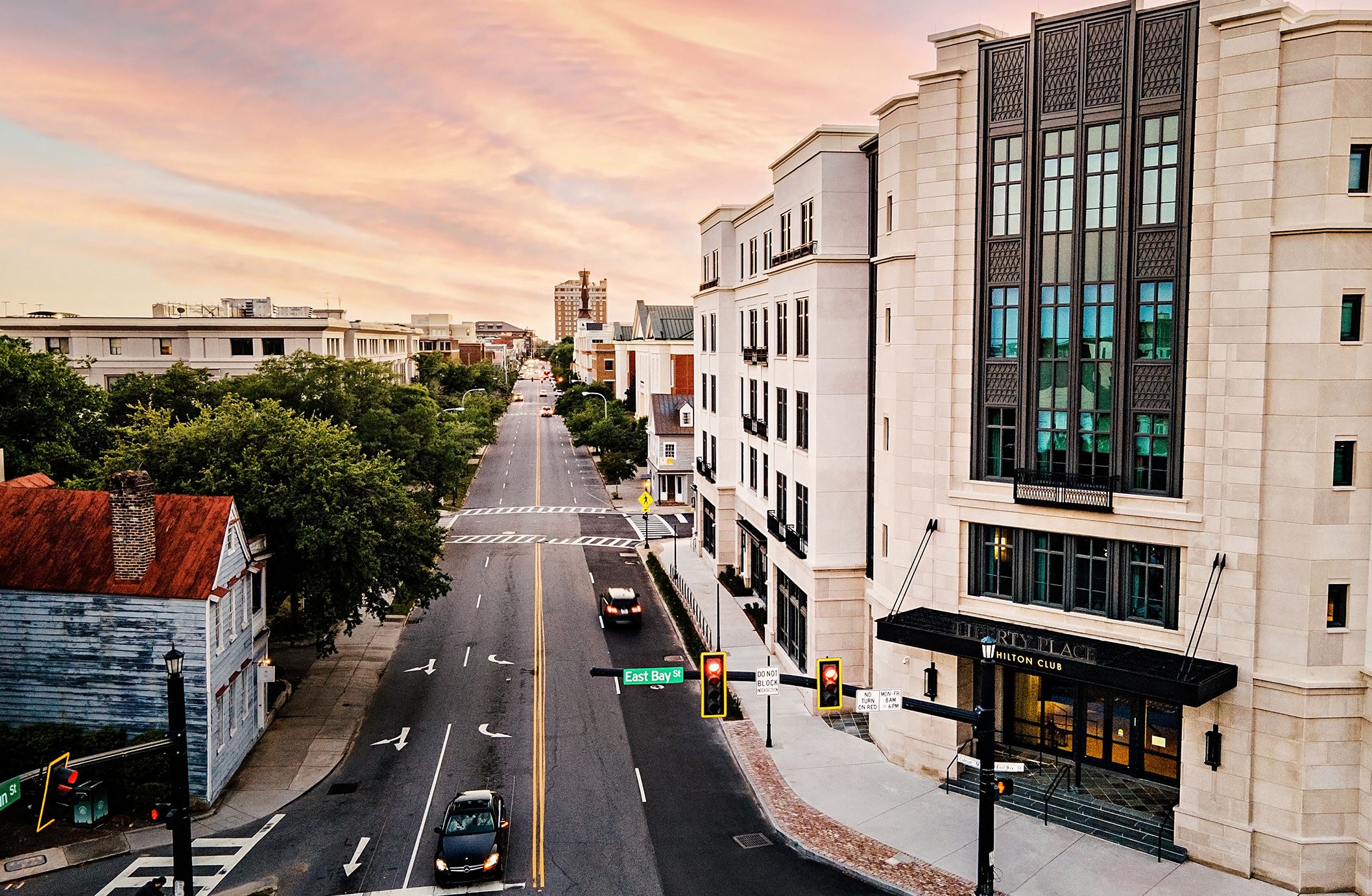 An aerial photo of the exterior of Hilton Club Liberty Place with the copy 'Charleston, South Carolina. Liberty Place. Dining & Bars'.