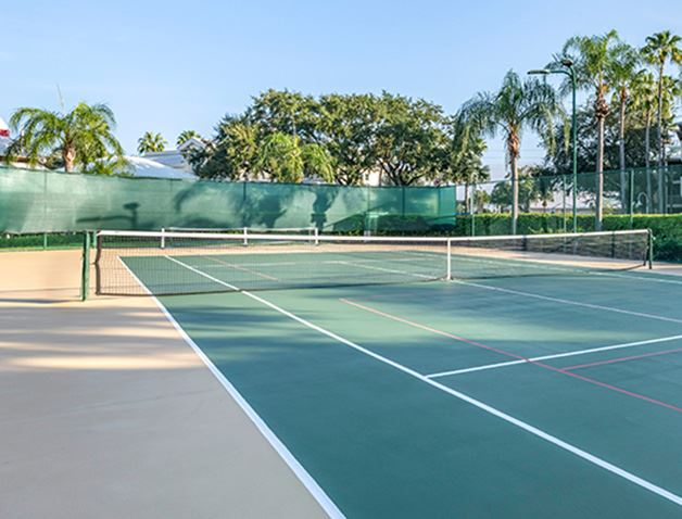 An photo of the exterior of a tennis court painted green and red at Hilton Vacation Club Grande Villas Orlando with the text 'Orlando, Florida. Grande Villas'