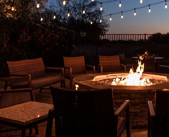 An night time photo of a fire pit burning at Hilton Vacation Club Scottsdale Villa Mirage with the text 'Scottsdale, Arizona. Villa Mirage'