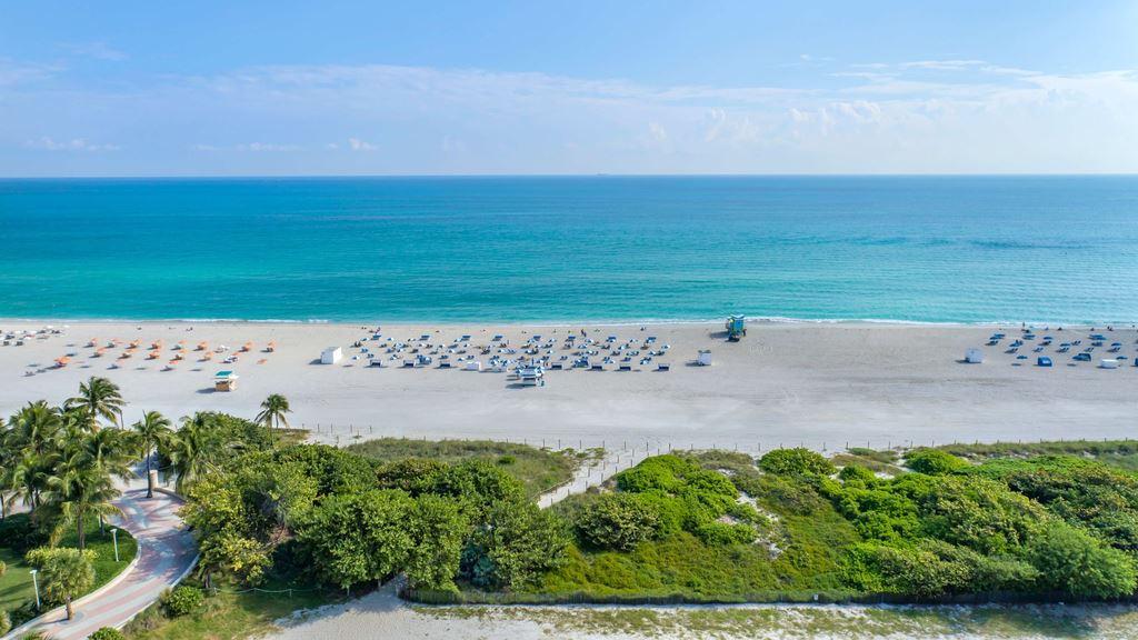 An arial photo of a Florida beach showing the sea and sand during the day time with the copy '4-night adventure to Miami'.